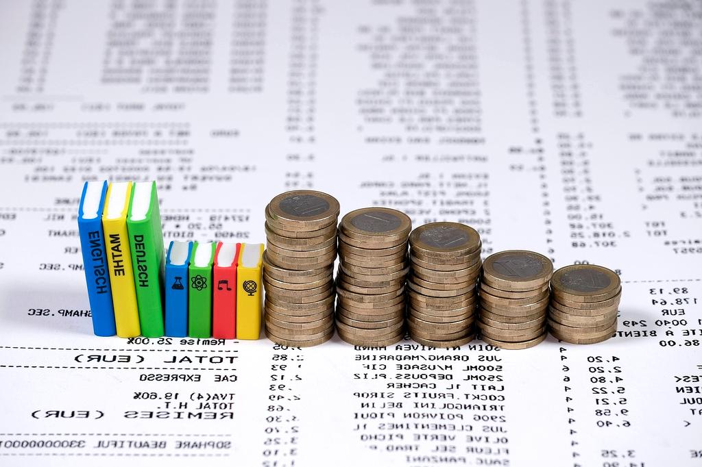 Hands counting euro bills and coins